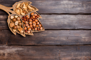Fototapeta premium Various nuts in wooden background