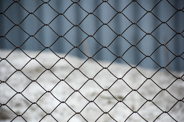 Background with metal mesh fence