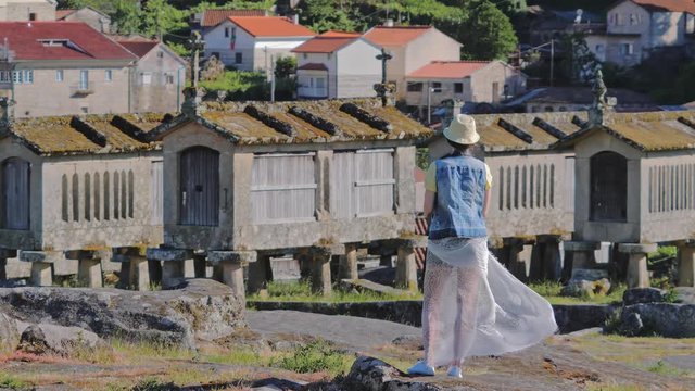 Woman tourist takes pictures of Espigueiros crowned in Soajo settlement