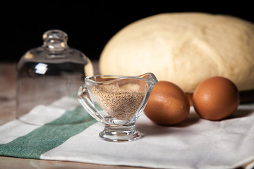 Bakery ingredients. On the table are flour, eggs and pastry dough