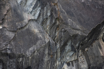 The surface of the marble rough stone of a large rock