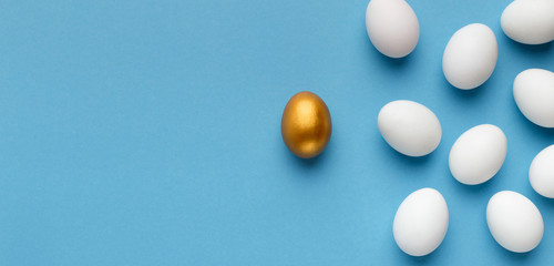 One unique golden egg standing opposite of identical ones - obrazy, fototapety, plakaty