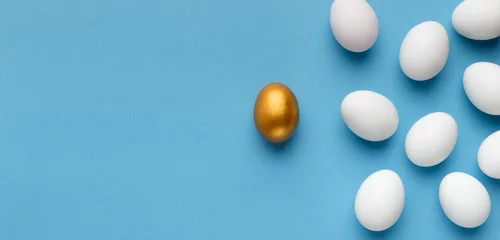 Foto op Plexiglas One unique golden egg standing opposite of identical ones © Prostock-studio