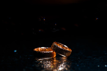 Beautiful wedding gold rings on dark background