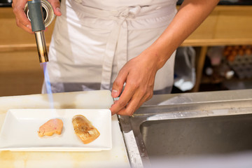 Japanese restaurant chef grilling   foie gras for making sushi