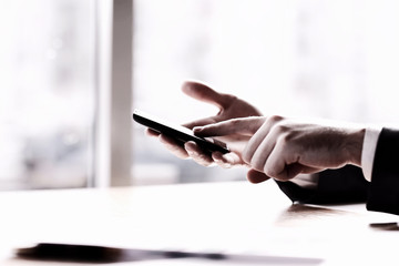 close up.modern man typing text on a smartphone