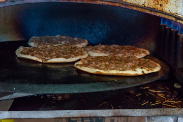 Preparing pita with lamb meat and chives on the stove