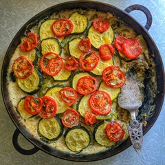 casserole with vegetables. zucchini, tomatoes, eggs, meat. in the pan.