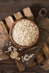 Oatmeal in a wooden bowl on a wooden table