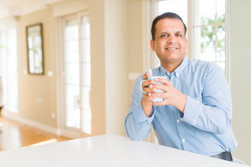 Middle age man enjoying and drinking a cup of coffee at home