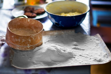 Traditional Wooden Sieve or Sifter, White Flour on a Tray, Mixing Bowl on the Table.