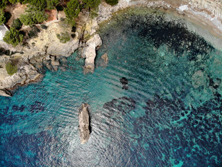 Cala en Cranc rocky seaside in the Palma de Majorca directly from above drone point of view photo, picturesque nature stony beach turquoise Mediterranean waters from top image, Balearic Islands Spain