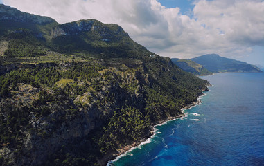 Obraz premium Picturesque aerial photo of rocky coastline of Son Marroig in the Palma de Mallorca touristic famous island, beautiful place Mediterranean sea cloudy sky at sunny summer day, Spain