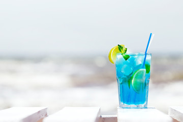 .blue cocktail with ice mint and lemon