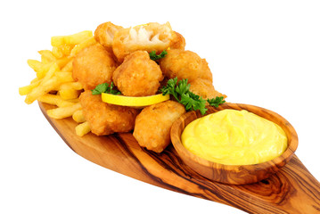 Battered cod nugget bites with potato French Fries and mayonnaise dip on an olive wood serving board isolated on a white background