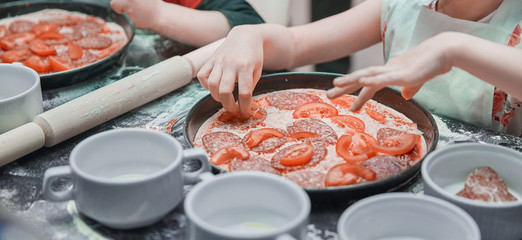 close up. a little girl on a master class in cooking pizza.