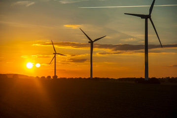 Fototapeta na wymiar Silhouette of wind turbines at sunset. The concept of alternative energy.