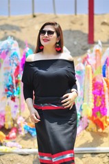 Middle aged Thai lady in colourful northern Thai style costume at outdoor tourist place background in Chiang Mai Lanna Thailand