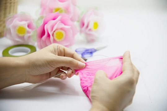 Woman making beautiful nylon flower - people with DIY handmade flower concept