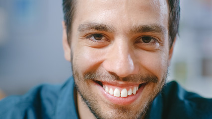 Close-up Portrait of Handsome Hispanic Young Man Smiling on Camera. 