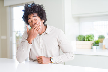 Fototapeta na wymiar African American man at home bored yawning tired covering mouth with hand. Restless and sleepiness.