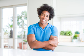 African American man at home happy face smiling with crossed arms looking at the camera. Positive person.