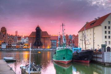 Fototapeta premium Beautiful port crane and the old town of Gdansk at sunset, Poland.