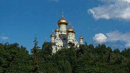 Fototapeta na wymiar Domes of the Orthodox Cathedral against the blue sky. Summer time.