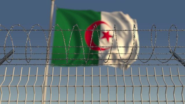 National flag of Algeria behind barbed wire fence. Conceptual loopable 3D animation