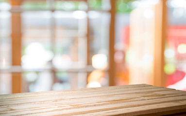 Empty of wood table top on blur of curtain with window view green from tree garden background.For...