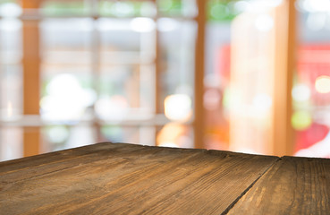 Empty of wood table top on blur of curtain with window view green from tree garden background.For montage product display or design key visual layout