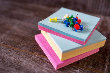 colorful push pins on wooden background