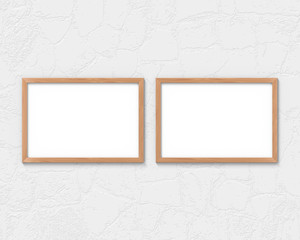 Set of 2 horizontal wooden frames mockup hanging on the wall. Empty base for picture or text. 3D rendering.