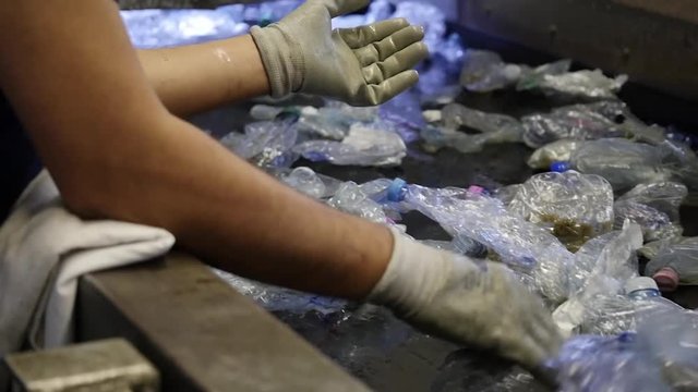 hands sort bottles-detail- plastic recycling process