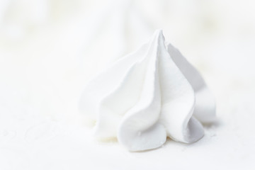 White meringue cake on white background