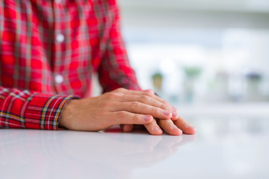 Close up of man hands with palms together over white table