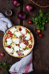 Homemade zucchini and cherry tomato tart with mozzarella