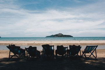 Group of friends lying on the bed at the beach.