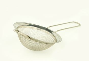 close up steel strainer on white