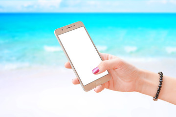 Woman use smart phone. Isolated screen for mockup. Close-up scene with a beach in the background.