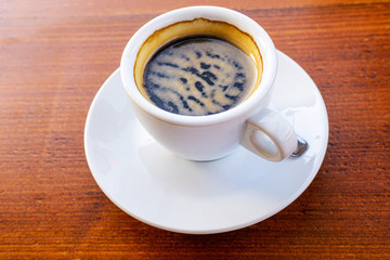 white cup of hot coffee on table