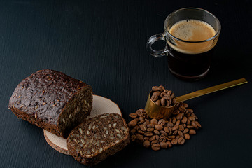 still life with black bread,black coffee beans and a mug of cappuccino