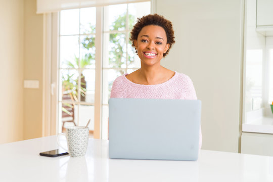 Young african american woman working using computer laptop with a happy and cool smile on face. Lucky person.