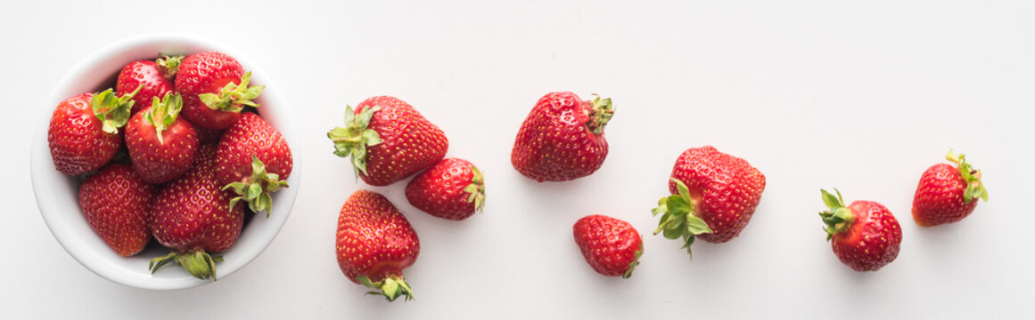 panoramic shot of fresh and ripe strawberries on white bowl