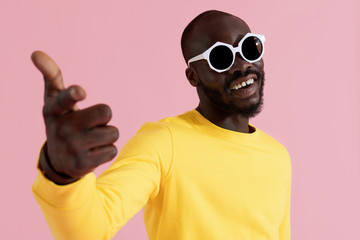Fashion. Happy black man in sunglasses and sweatshirt portrait