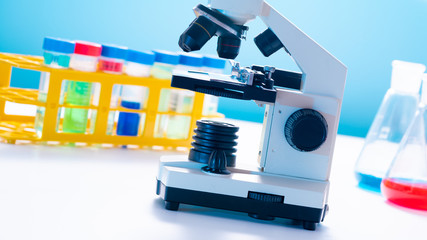 Microscope and test tubes  on laboratoy table