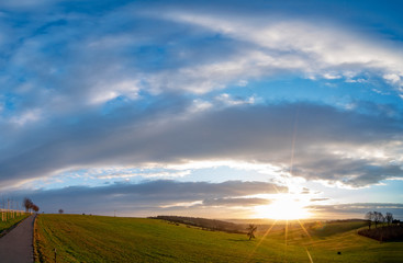Fototapeta premium Sunrise in spring field at early morning