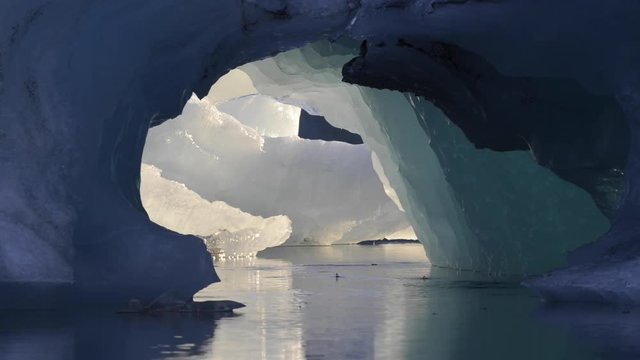 Poetic video of floating icebergs on J&ouml;kuls&aacute;rl&oacute;n glacial river lagoon during a summer night with midnight sun, at Vatnaj&ouml;kull National Park