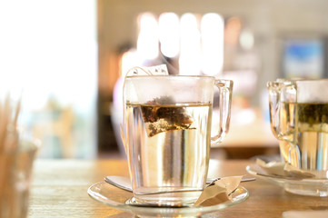 A cup of tea with a tea bag slowly sinking in