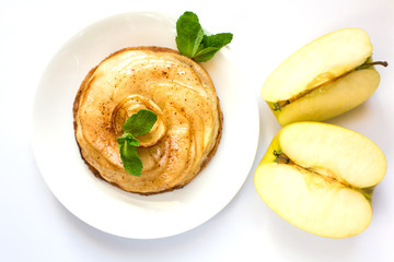 Round cake made from apple charlotte with mint leaves close-up on a white background. Isolate